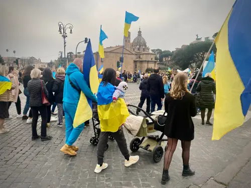 Families gathered in solidarity, holding Ukrainian flags
