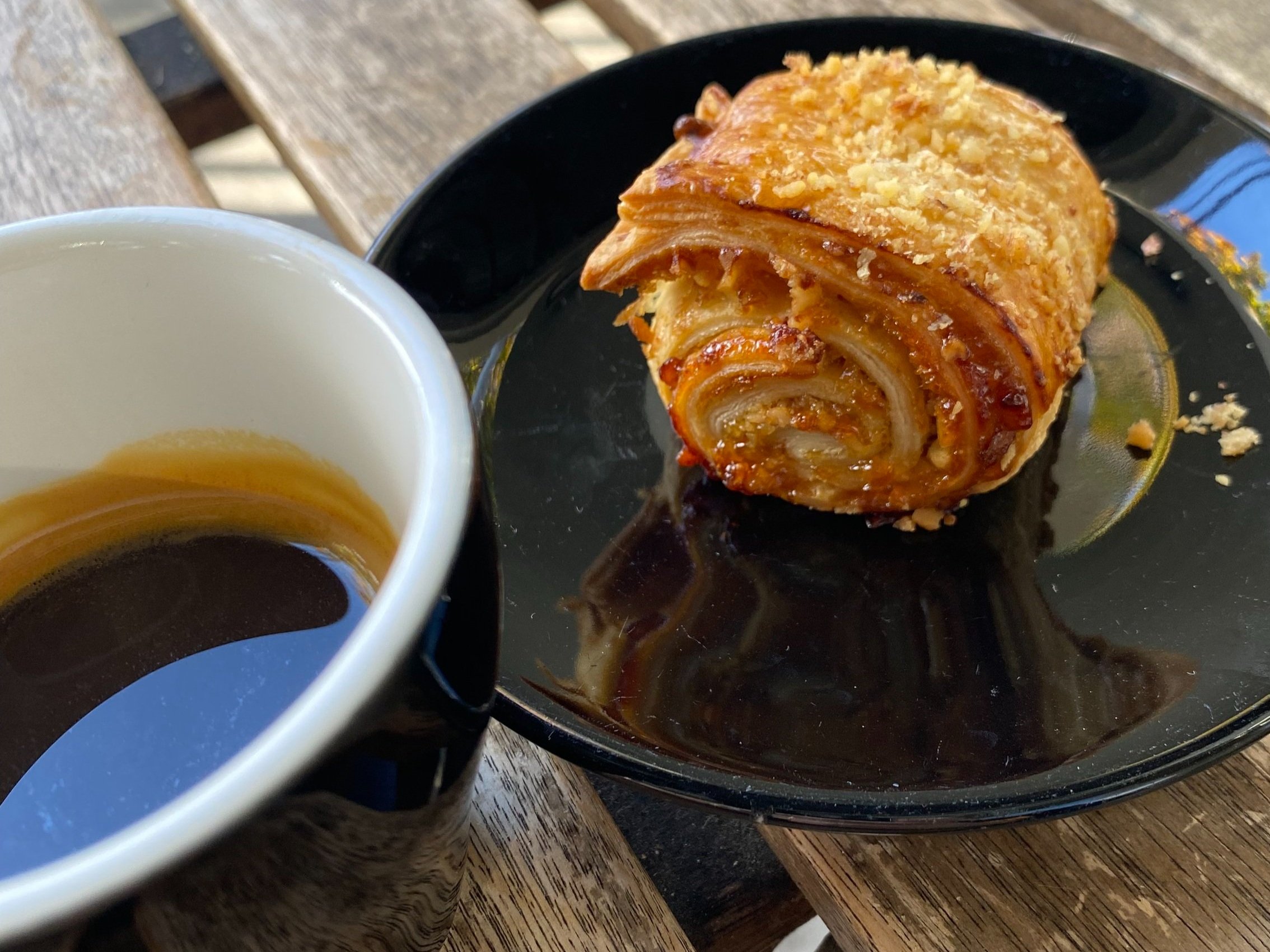 A flaky rugelach beside an espresso — the monthly Rugelach Club